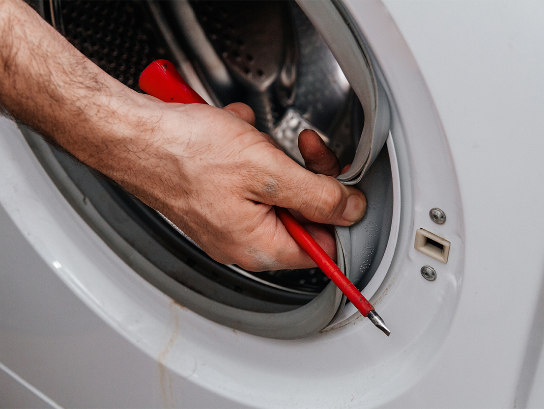handyman repairing washing machine